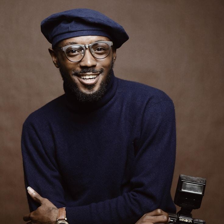 Avery Chen, Lead Design Curator at OpenStableOrigin, reviewing corporate floral arrangements